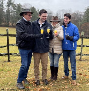Scott, Scott, Susan and Jack McDowell-Harvey ward off the rain with mimosas. (Photo © 2024 by Nancy Jaffer)